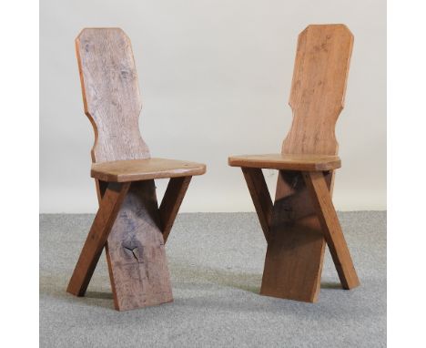 A pair of Victorian light oak hall chairs, each having a solid back and seat