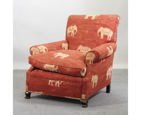 An early 20th century armchair, with elephant print upholstery