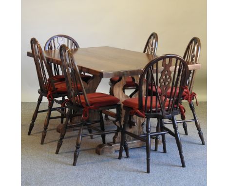 A set of four Ercol dark elm hoop back dining chairs, together with a pair of wheel back chairs and an oak refectory table, 1