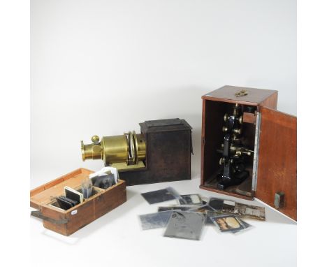 A vintage slide projector, with slides, together with a Hearson no521 microscope, cased and a box of decorative plates