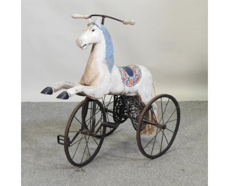 A vintage child's tricycle in the form of a horse, 85cm high