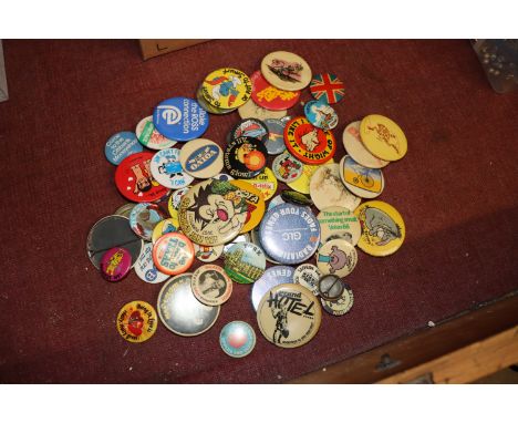 A box of various vintage badges