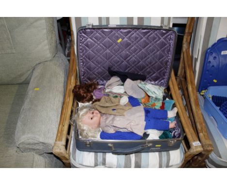 A vintage case and contents of dressed dolls and clothes 