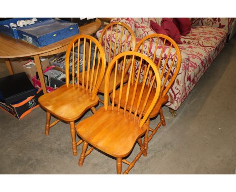 A set of four kitchen stick back chairs 