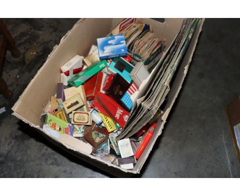 A box of various vintage matchboxes, cigarette packets, scrap album, beer mats, etc.
