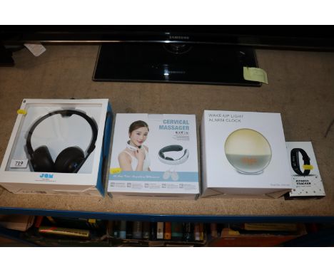 A pair of headphones; a wake up light alarm clock; fitness tracker and a cervical massager