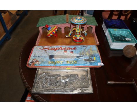 A vintage paint box, two tin plate toys, a child's garage etc.