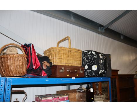 A wicker hamper; a vintage suitcase and two modern items of luggage