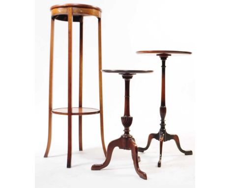 An early 20th Century mahogany two tiered torchere / plant stand having circular table tops with stencil decoration, on four 