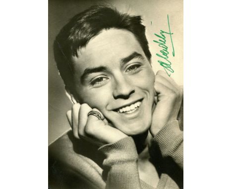 DELON ALAIN: (1935- ) French Actor. Signed postcard photograph, the UFA image depicting a very young Delon in a head and shou