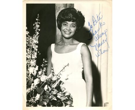 WILSON NANCY: (1937-2018) American singer. Vintage signed and inscribed 8 x 10 photograph of Wilson standing in a three-quart
