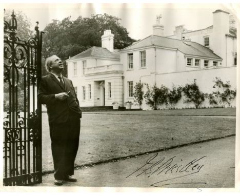 PRIESTLEY J. B.: (1894-1984) English novelist and playwright. Signed 10 x 7.5 photograph of Priestley standing outdoors in a 