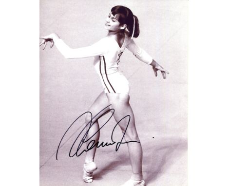 COMANECI NADIA: (1961- ) Romanian Gymnast. Five times Olympic individual gold medallist. Comaneci is the first Gymnast to be 