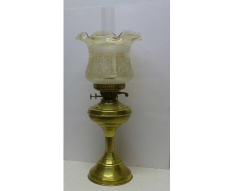 A Victorian brass oil lamp with chimney and etched glass shade 