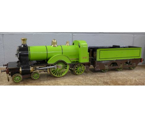 A 3.5 inch gauge coal-fired live steam model of a 4-4-2 Great Northern Railway Stirling Single locomotive and tender. Silver 