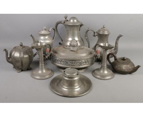 A quantity of metalware. Includes pair of pewter chamber candlestick with scrolling handles, ornate tureen, teapots, capstan 