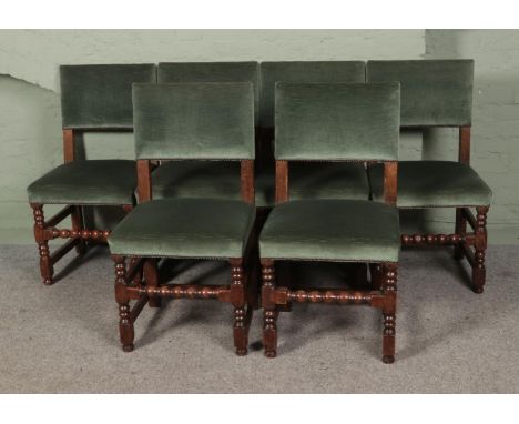 A collection of six green velvet upholstered chairs featuring bobbin turned supports.  