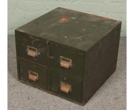 A green metal bank of four drawers with small contents of tools.  