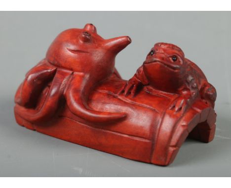 A Japanese carved Netsuke in the form of a Kappa and octopus on barrel  