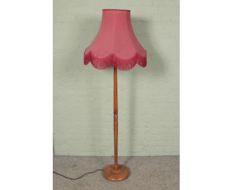 A wooden turned standard lamp  