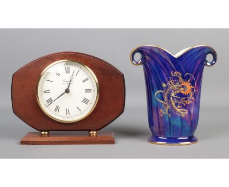 A Crown Devon blue lustre vase depicting an oriental style dragon, together with a quartz Comitti mantle clock. Vase 17.5cm t