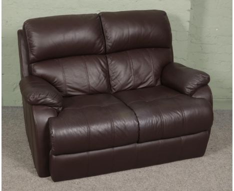 Two brown leather two seater sofas along with a complete leather sofa care kit.  