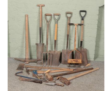 A collection of tools. Includes shovels, axes, pick, sledge hammers etc.  