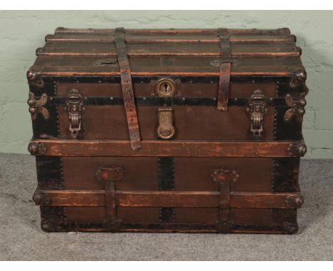 A large wooden bound trunk featuring Eagle Co. locks. Approx. dimensions 60cm x 87cm x 53cm.  