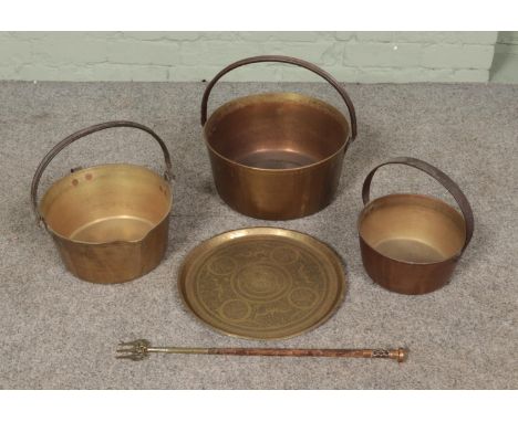 A collection of brass ware. Includes three graduated jam pans, Eastern dish and a toasting fork.  