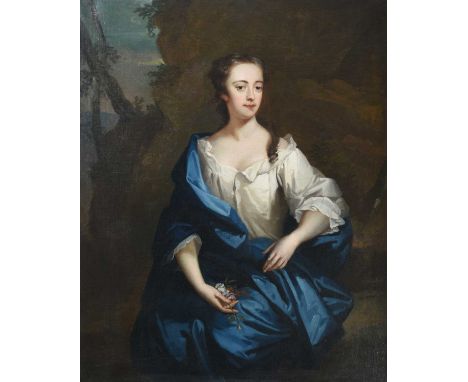 Follower of Sir Godfrey Kneller (1646-1723)Portrait of a young beauty at rest in a rocky landscape, holding a handful of flow