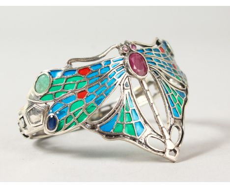 A SILVER, RUBY, EMERALD AND SAPPHIRE SET DRAGONFLY BANGLE.