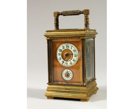 A MINIATURE BRASS CARRIAGE CLOCK, with alarm and subsidiary dial. 12cms high.