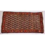 A PERSIAN CARPET, cream ground with Boteh decoration. 260cms x 135cms.