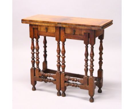 A 17TH CENTURY AND LATER WALNUT FOLD-OVER GATE-LEG TABLE, with quarter veneered top, later leather writing surface, two small