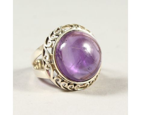 A SILVER AND AMETHYST RING.