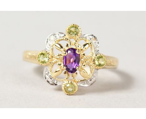 A 9CT GOLD, AMETHYST, PERIDOT AND DIAMOND RING.