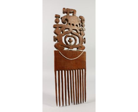 A GOOD LARGE CARVED WOOD TRIBAL COMB carved with a bison and an elephant. 39cms long x 13cms wide.