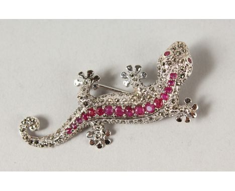 A SILVER RUBY SET LIZARD BROOCH.