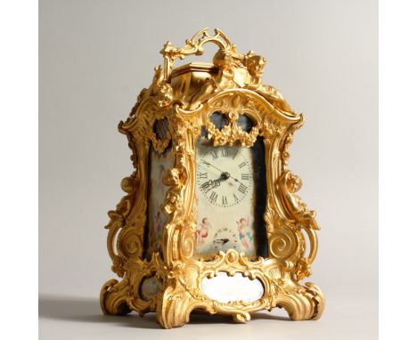 A SEVRES STYLE ORMOLU CARRIAGE CLOCK, with decorative porcelain panels. 23cms high.