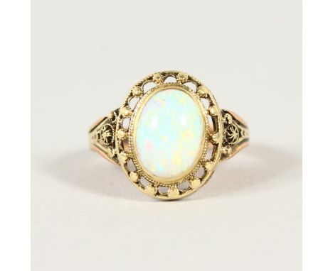 a yellow gold and opal ring.