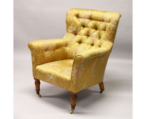 HAMPTONS OF PALL MALL, A LATE 19TH CENTURY ARMCHAIR with button upholstery, turned front legs, brass castors, back leg stampe