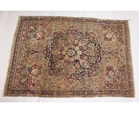 AN EARLY 20TH CENTURY PERSIAN CARPET, blue and claret ground with stylised floral decoration, within a conforming border. 276