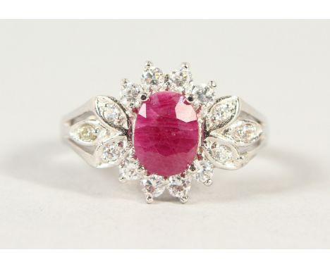A SILVER, RUBY AND CZ RING.
