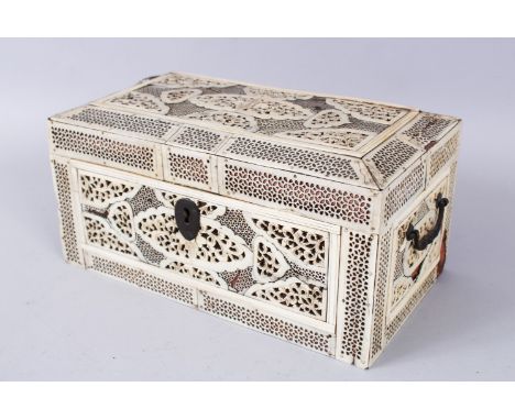 A GOOD 19TH CENTURY PIERCED IVORY CANTON THREE DIVISION TEA CADDY, with wooden liner, carrying handles to the sides, 24cm lon