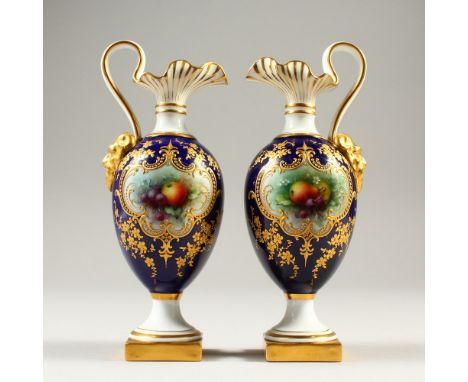 A GOOD SMALL PAIR OF ROYAL WORCESTER EWERS, blue ground with fruit painted cartouches by Chivers, satyre mask handles on squa