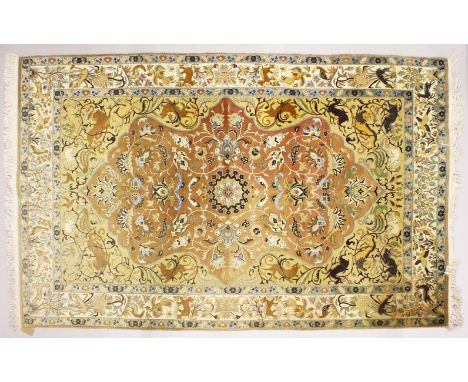 A GOOD PERSIAN CARPET, with rust ground floral panel within a beige ground border depicting animals and birds. 310cms x 185cm