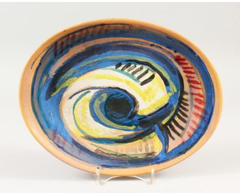 QUENTIN BELL (FULHAM POTTERY). AN OVAL DISH with blue and yellow scrolls. Signed on reverse. 33cms long.