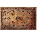 A LARGE CHINESE CARPET, salmon ground, decorated with flowers and birds in a similar border. 3.6m