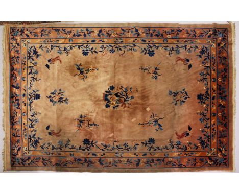 A LARGE CHINESE CARPET, salmon ground, decorated with flowers and birds in a similar border. 3.6m x 2.5m.