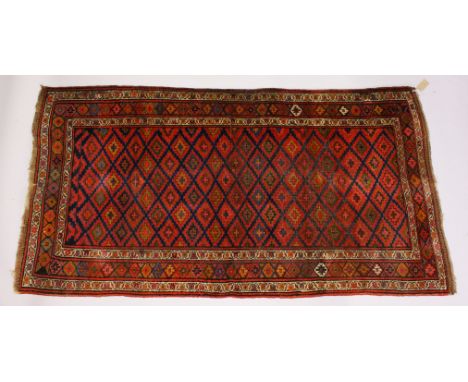 A PERSIAN CARPET, the central panel with all over stylized decoration in a similar border. 250cms x 135cms.